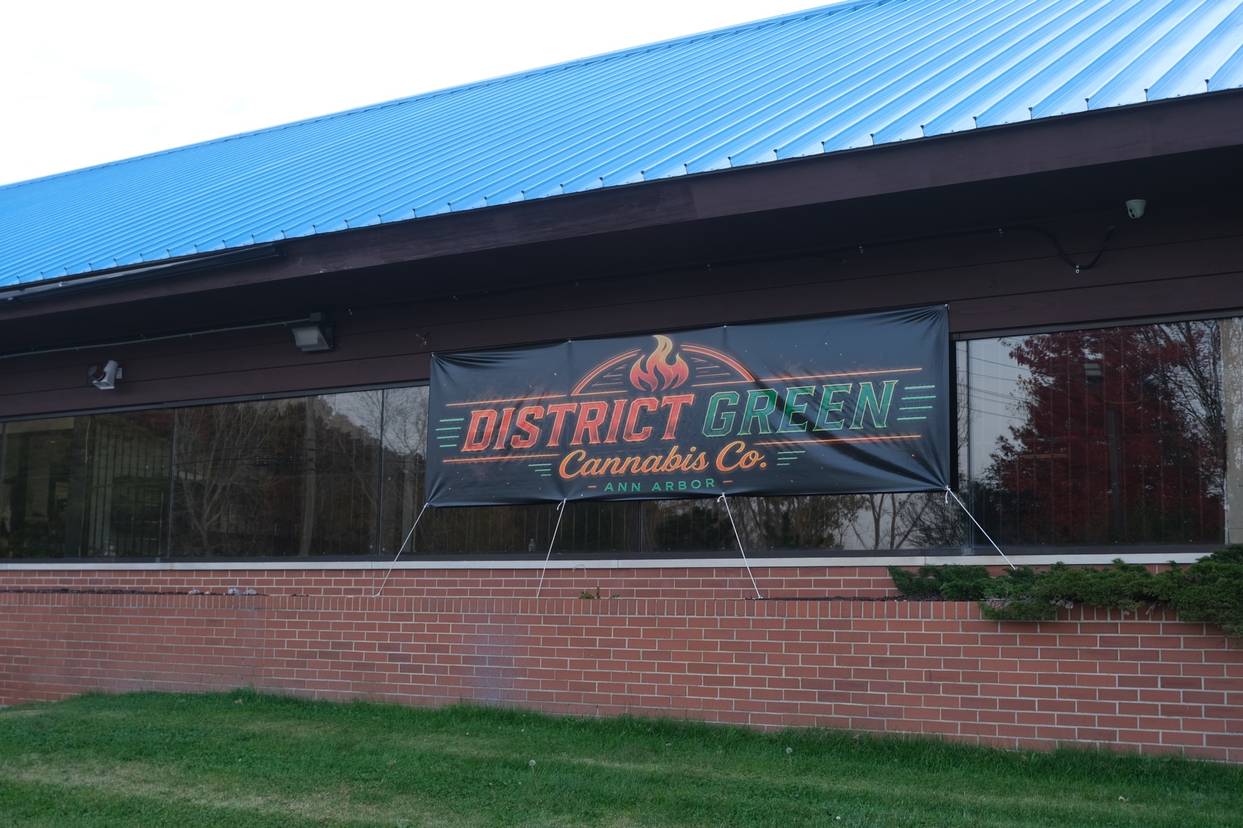 District Green banner across the storefront