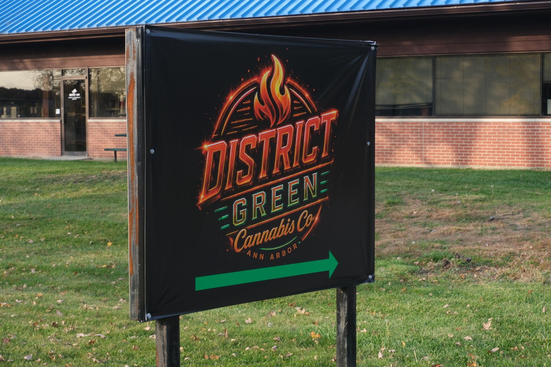 District Green roadside sign outside the store